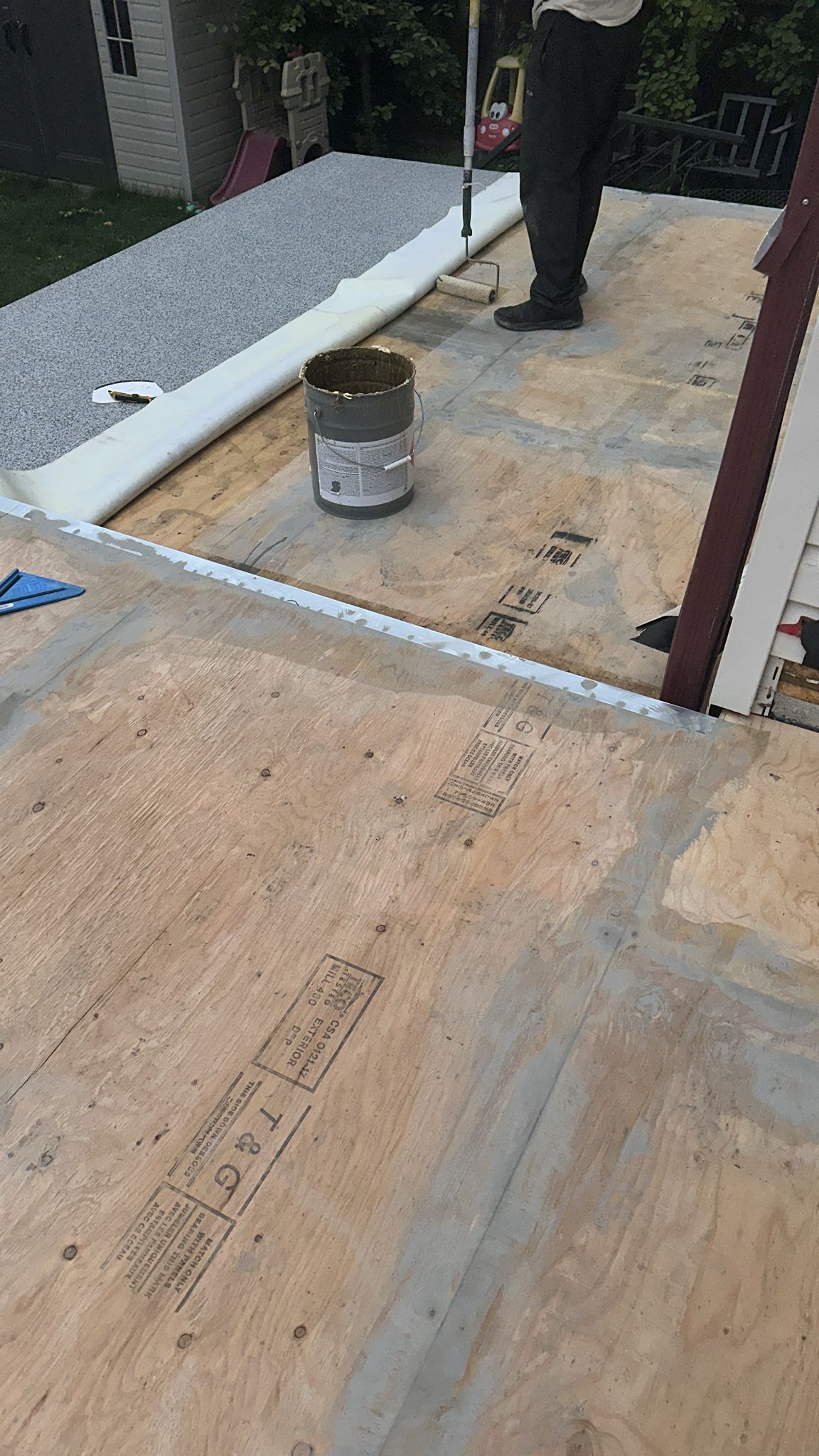 NW Ridge crew member applying a waterproof vinyl deck membrane on a job site